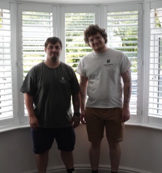 Andy and Brad, co-founders of Greystone Shutters, in front of a finished bay window install in the West Midlands