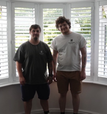 Andy and Brad, co-founders of Greystone Shutters, in front of a finished bay window install in the West Midlands