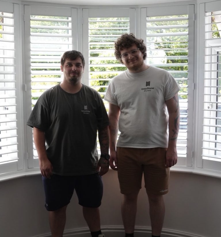 Andy and Brad, co-founders of Greystone Shutters, in front of a finished bay window install in the West Midlands