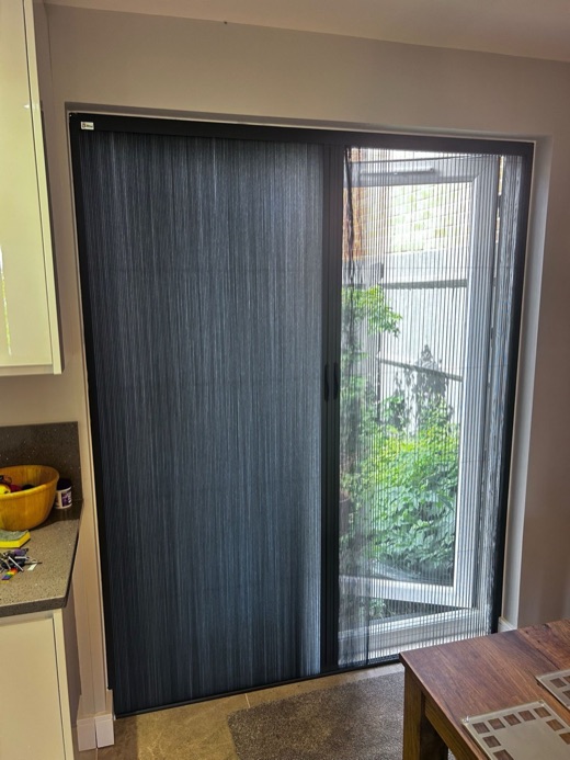 One French door covered with the grey Scene Set fabric pulled across, the other left clear