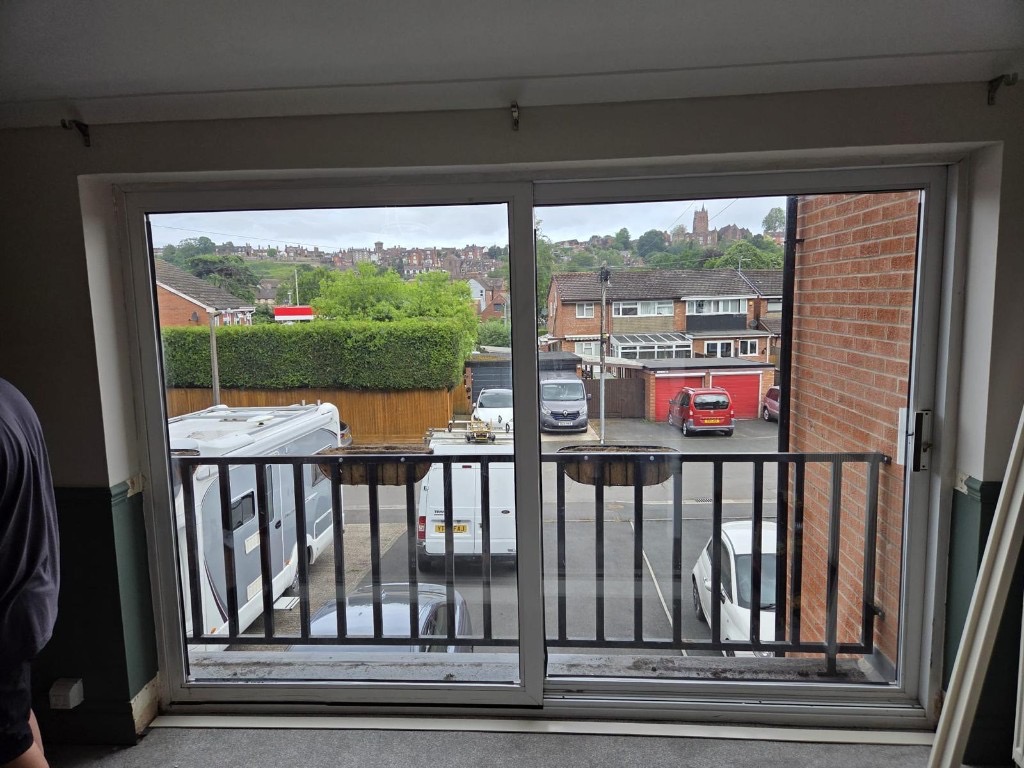 Sliding glass doors in Bridgnorth before tracked shutters were fitted, with shutter frames on site ready to install