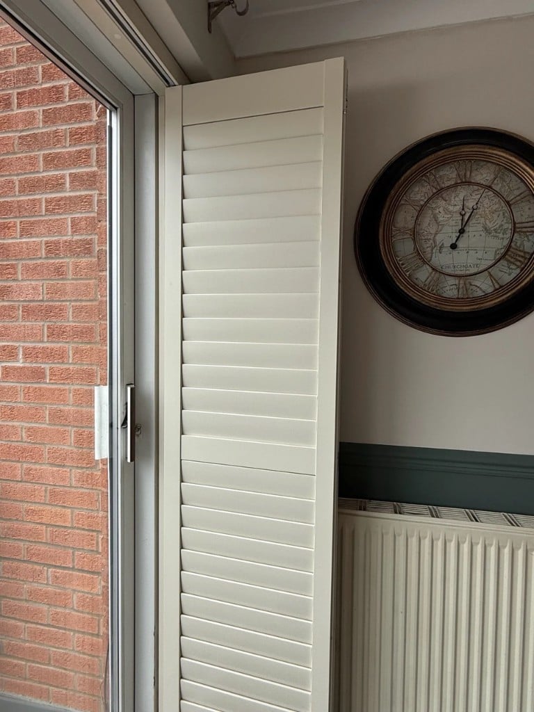Grey-beige shutter panel on a glass door