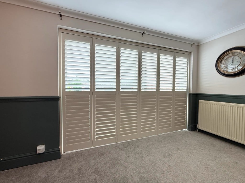 Grey-beige shutters across a wide opening in Sandwell