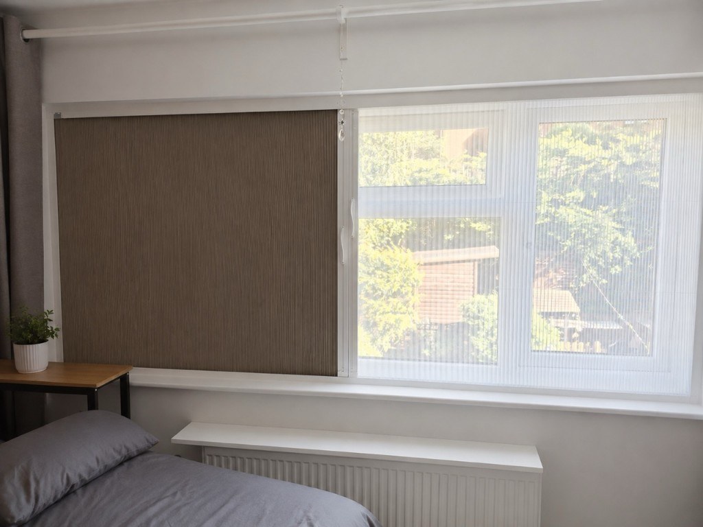 Bedroom window in Stourbridge with half blackout fabric and half bug screen mesh in a white BlindScreen frame