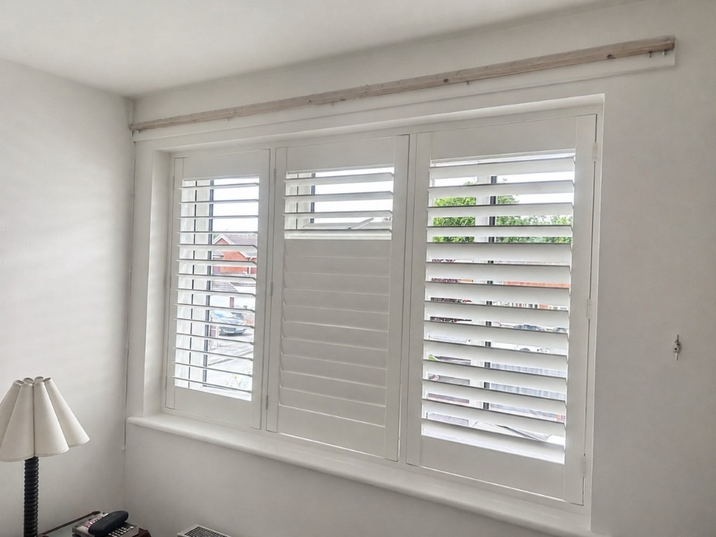 Wednesbury bedroom with full height composite shutters in Silk White, split tilt with lower louvres closed and upper louvres open