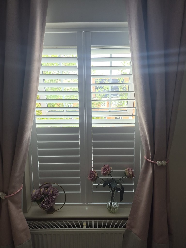 Baggeridge bedroom 1 square window with two-panel Pure White shutters, 50% split tilt with upper louvres open