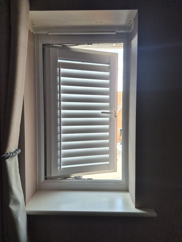 Baggeridge bedroom 2 Perfect Fit shutter in Pure White on a casement window, swung open with the window