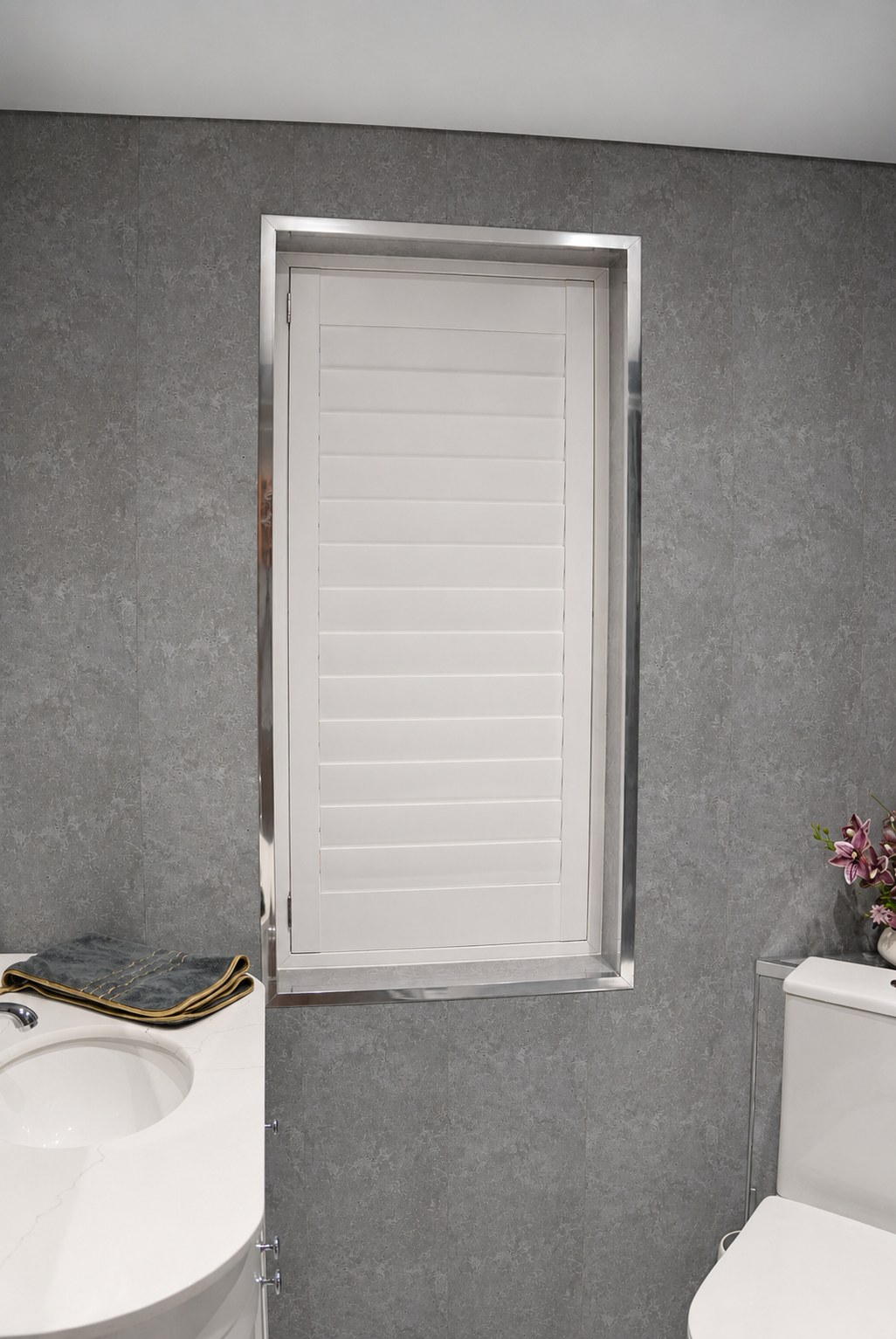 Brierley Hill bathroom with Pure White waterproof shutters, single panel with all louvres fully closed