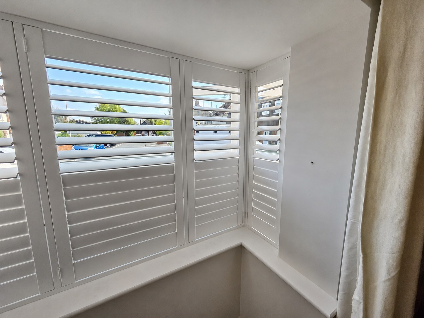 Halesowen box bay shutters with split tilt set, lower louvres closed and upper louvres open, hidden tilt rod