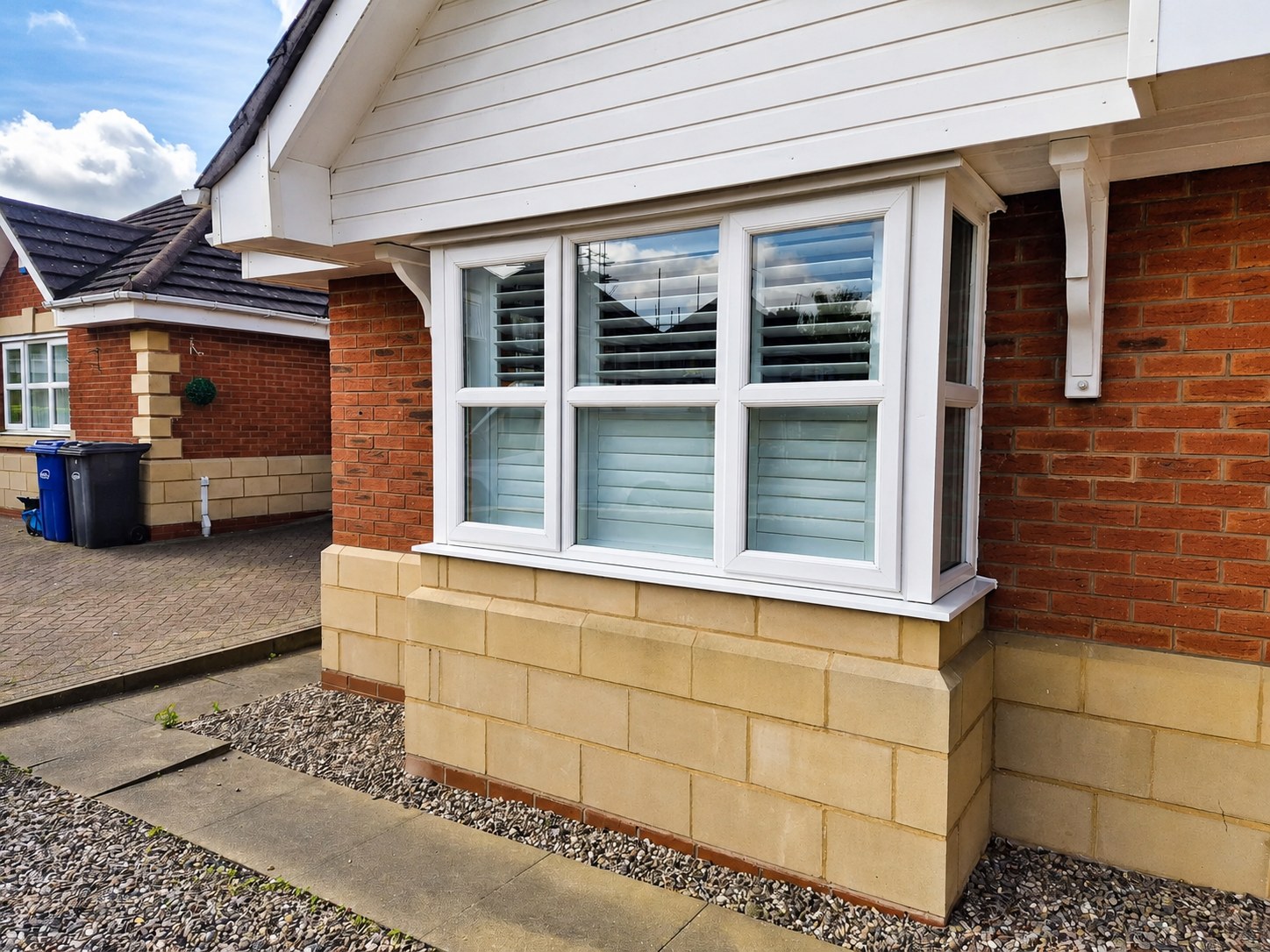 Halesowen home with Pure White box bay shutters, kerb view from the side