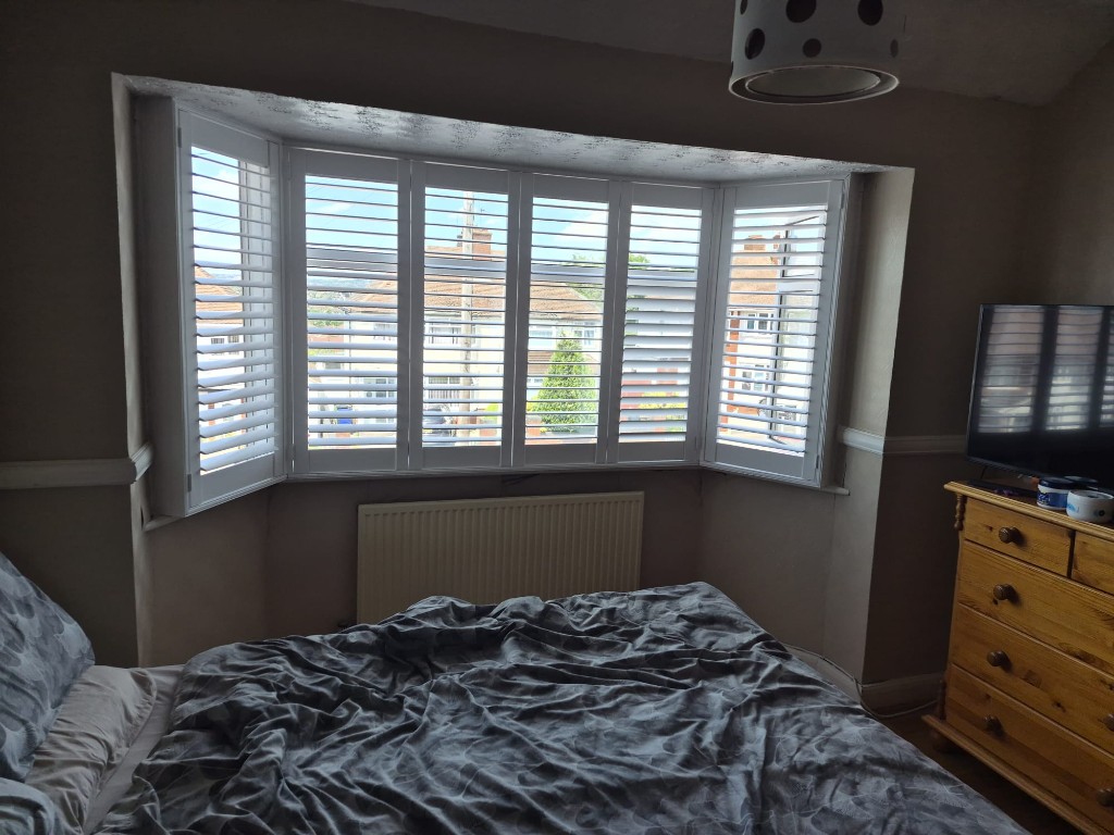 Halesowen upstairs bedroom bay with Pure White shutters, upper louvres open and lower louvres closed for privacy