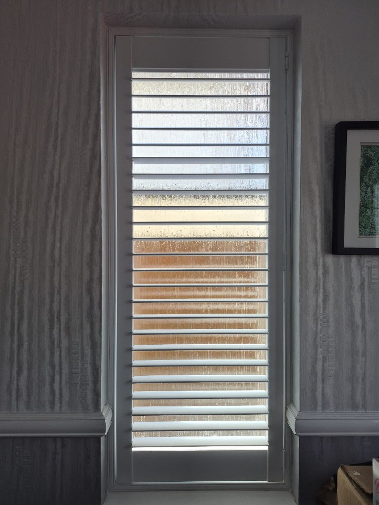 Halesowen hallway shutter in Pure White with split tilt, upper louvres open and lower louvres closed