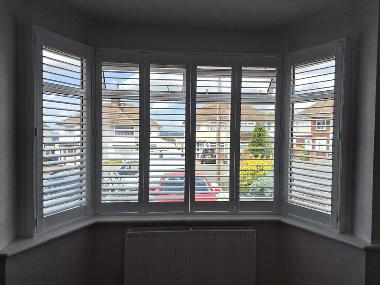Pure White full height shutters on a Halesowen living room bay window with split tilt