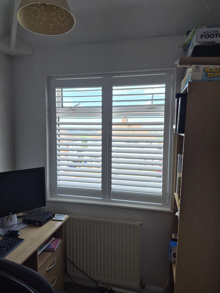 Halesowen home office with two-panel Pure White shutters, split tilt with upper louvres open above the desk