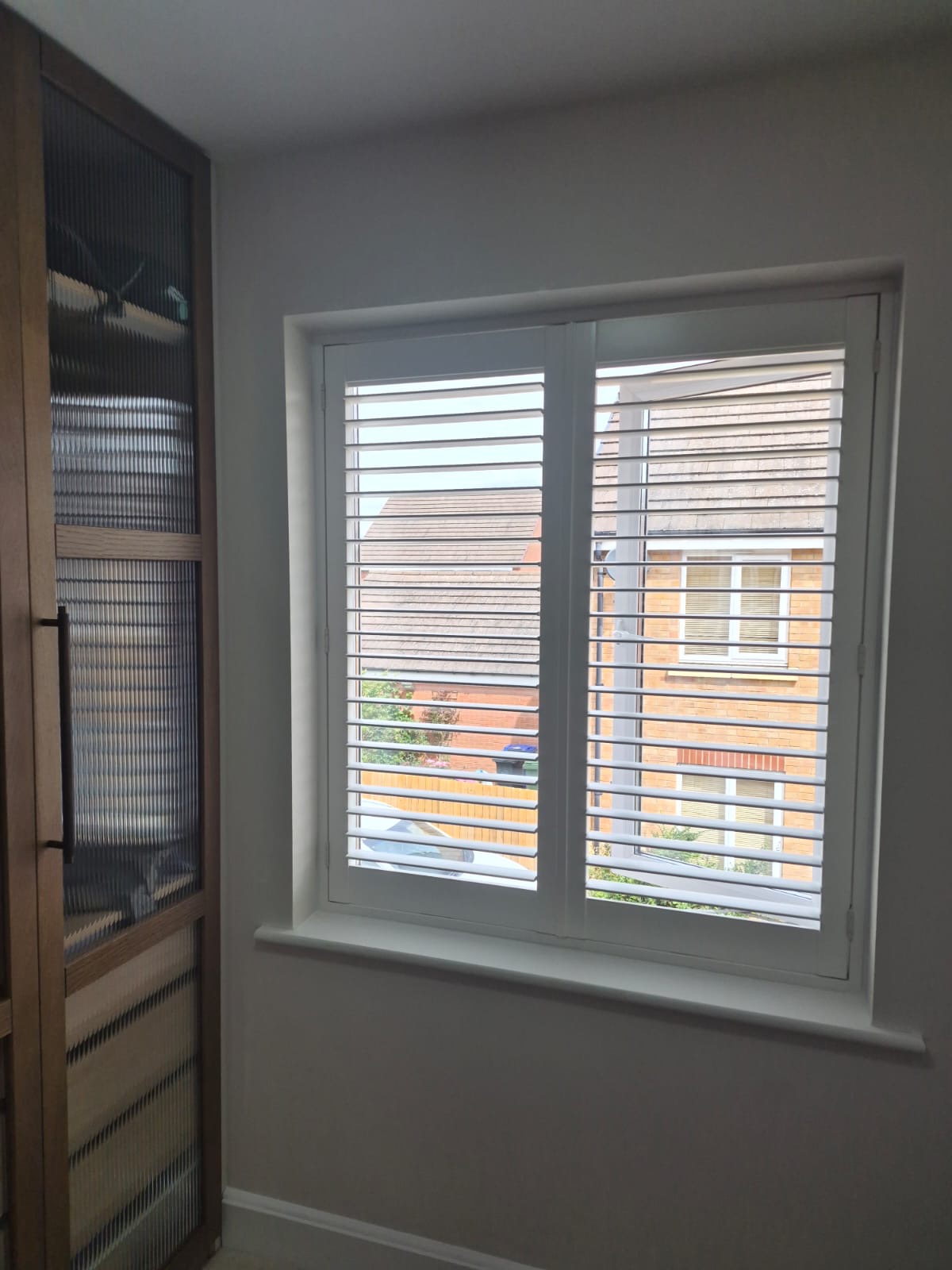 Kingswinford bedroom with full height composite shutters in Silk White, louvres tilted open