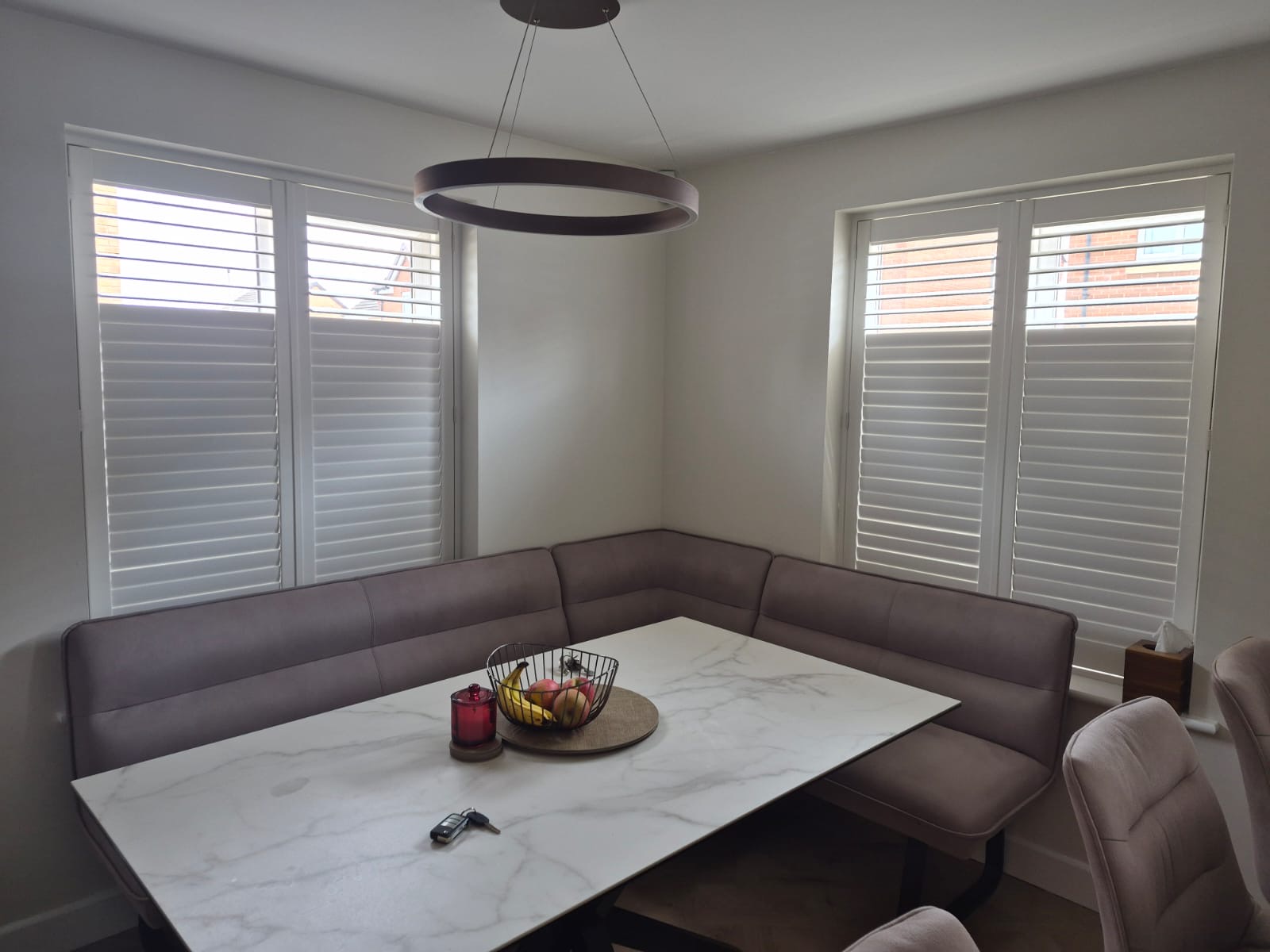 Kingswinford dining area composite shutters in Silk White above the table, split tilt set part way up the panels