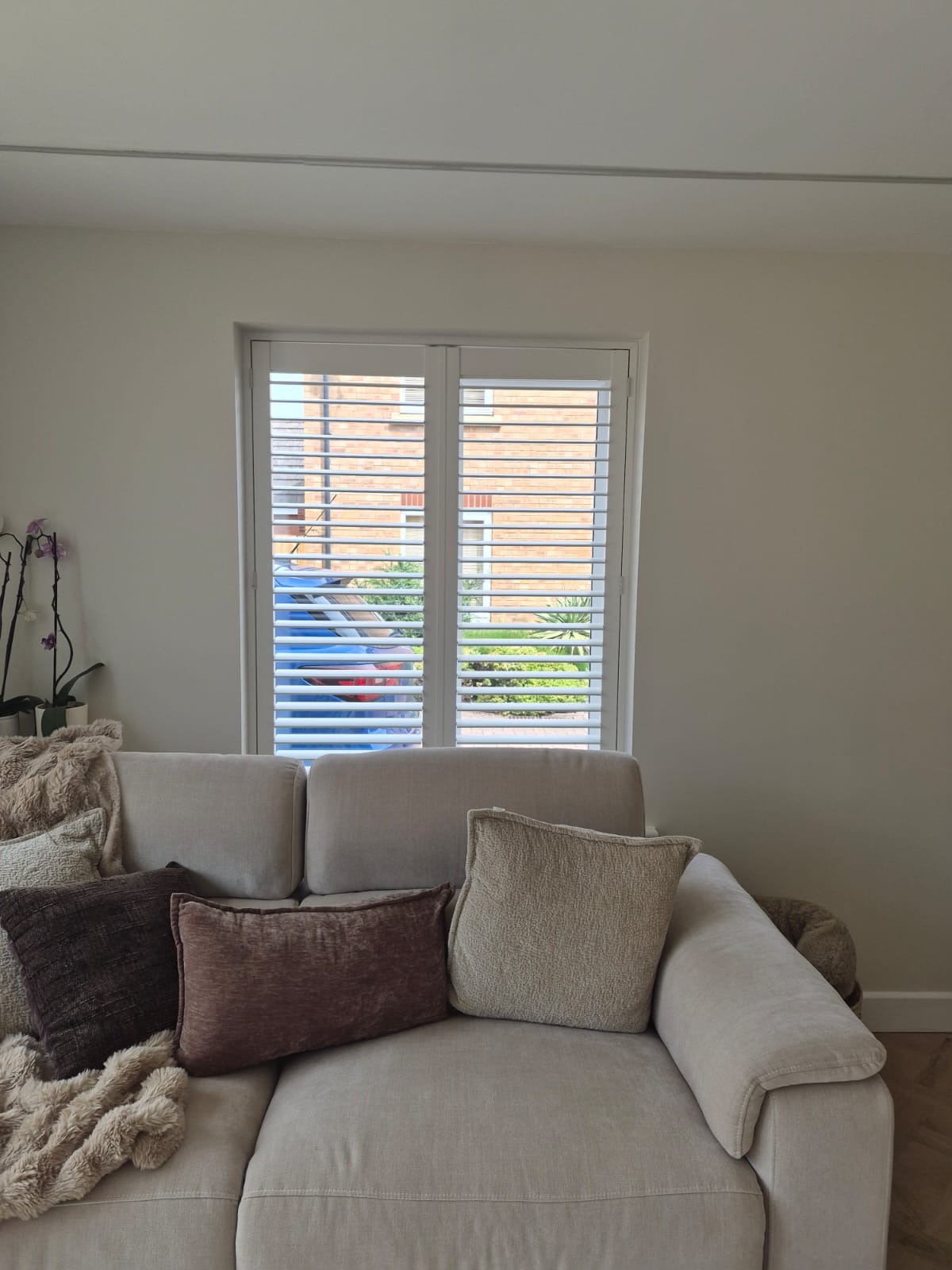 Kingswinford living room with full height composite shutters in Silk White, louvres tilted open