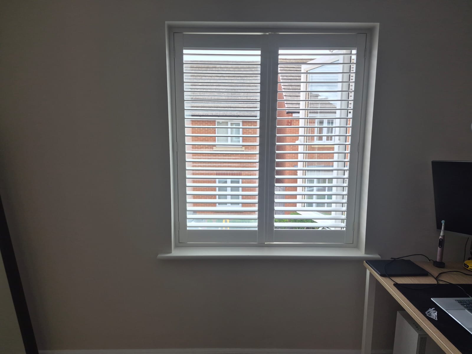 Kingswinford home office composite shutters in Silk White with dual monitors behind the louvres