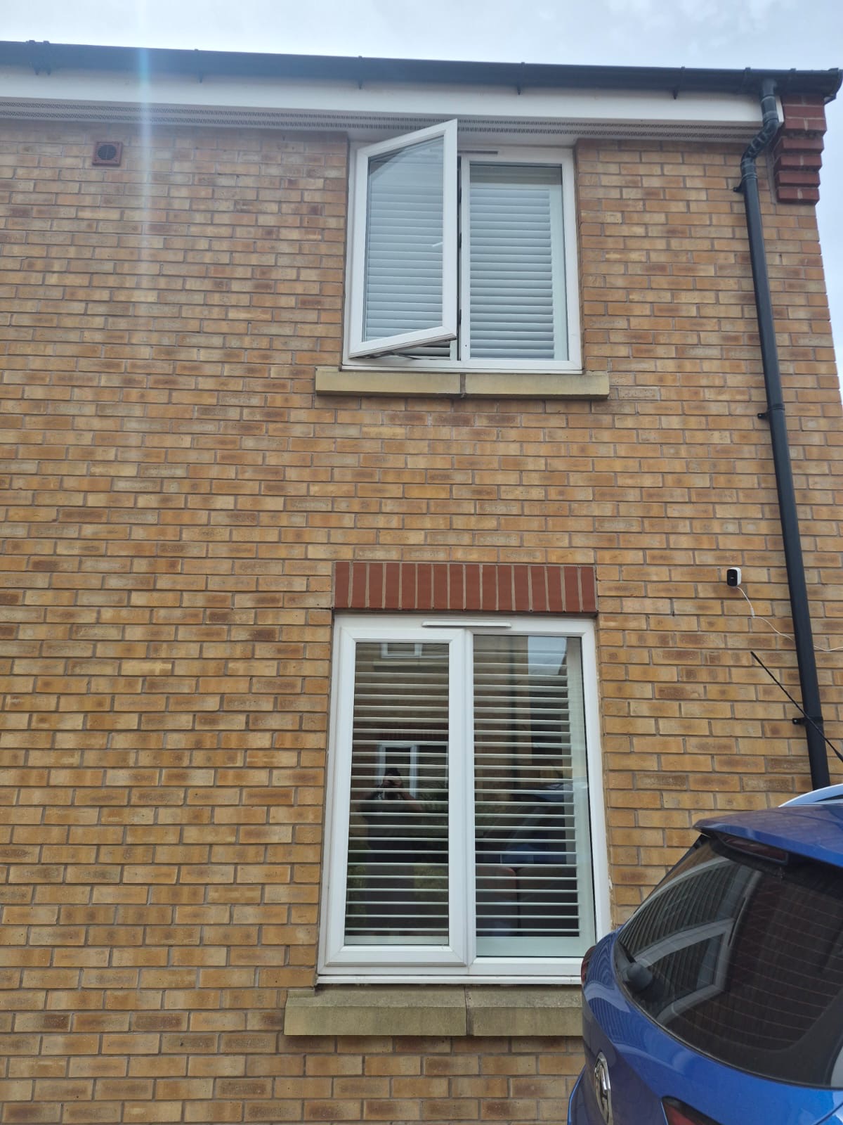 Kingswinford brick house with two floors of Silk White composite shutters fitted inside the windows