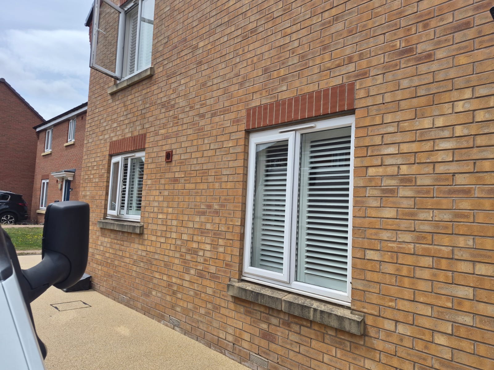 Kingswinford ground-floor window with Silk White composite shutters fitted inside the brick reveal