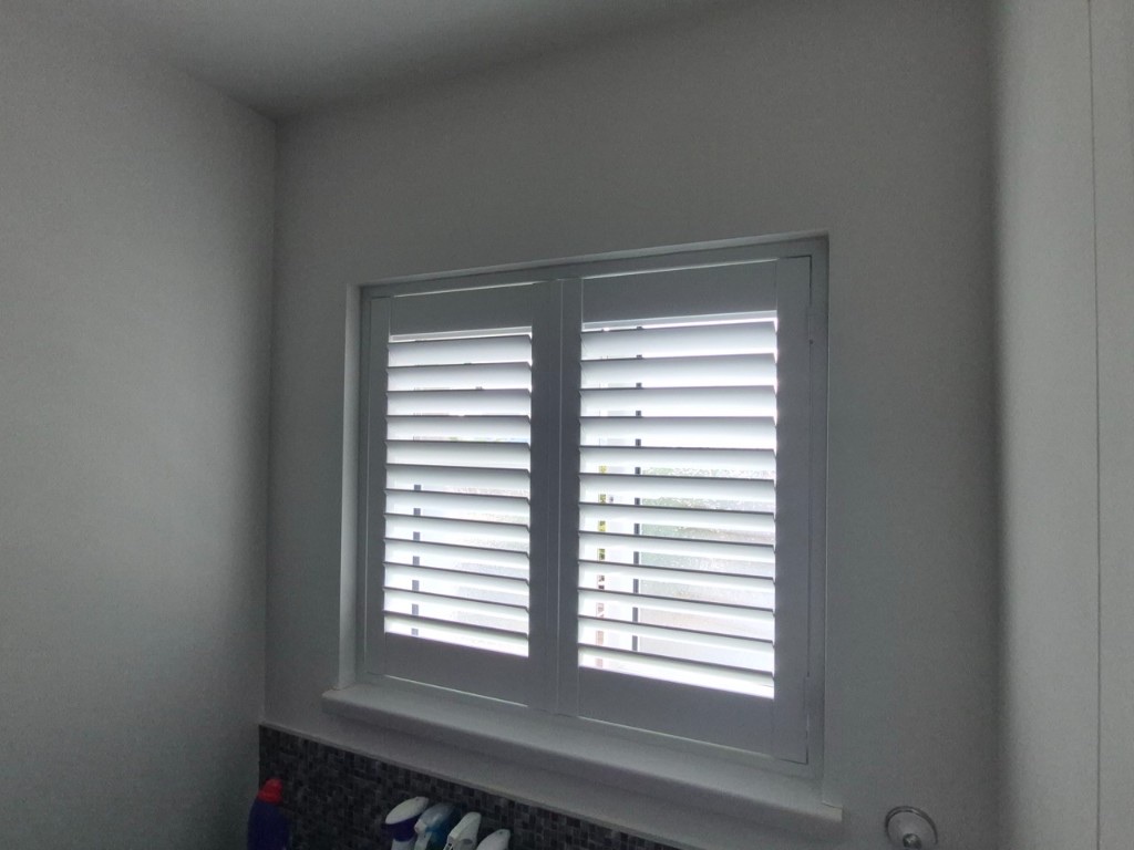 Netherton bathroom Pure White full height composite shutters with 63mm louvres open