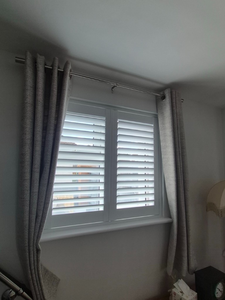 Netherton downstairs hallway Pure White full height composite shutter on a narrow window, louvres open