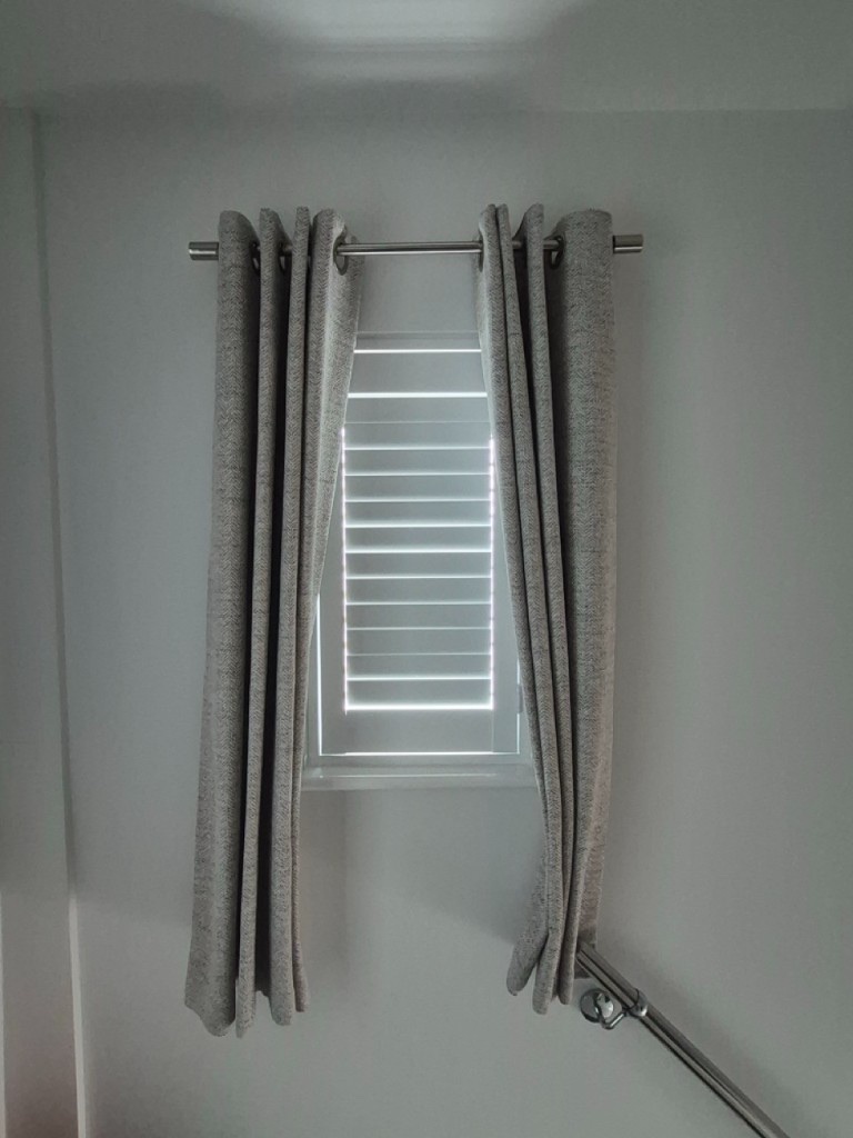 Netherton upstairs hallway Pure White composite shutter with louvres closed