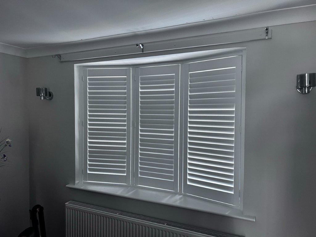 Dining room bay Pure White composite shutters with louvres closed for privacy