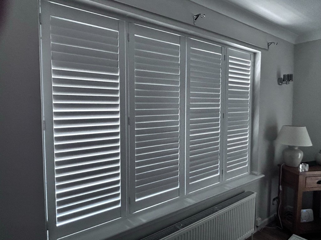 Living room Pure White composite shutters with louvres closed