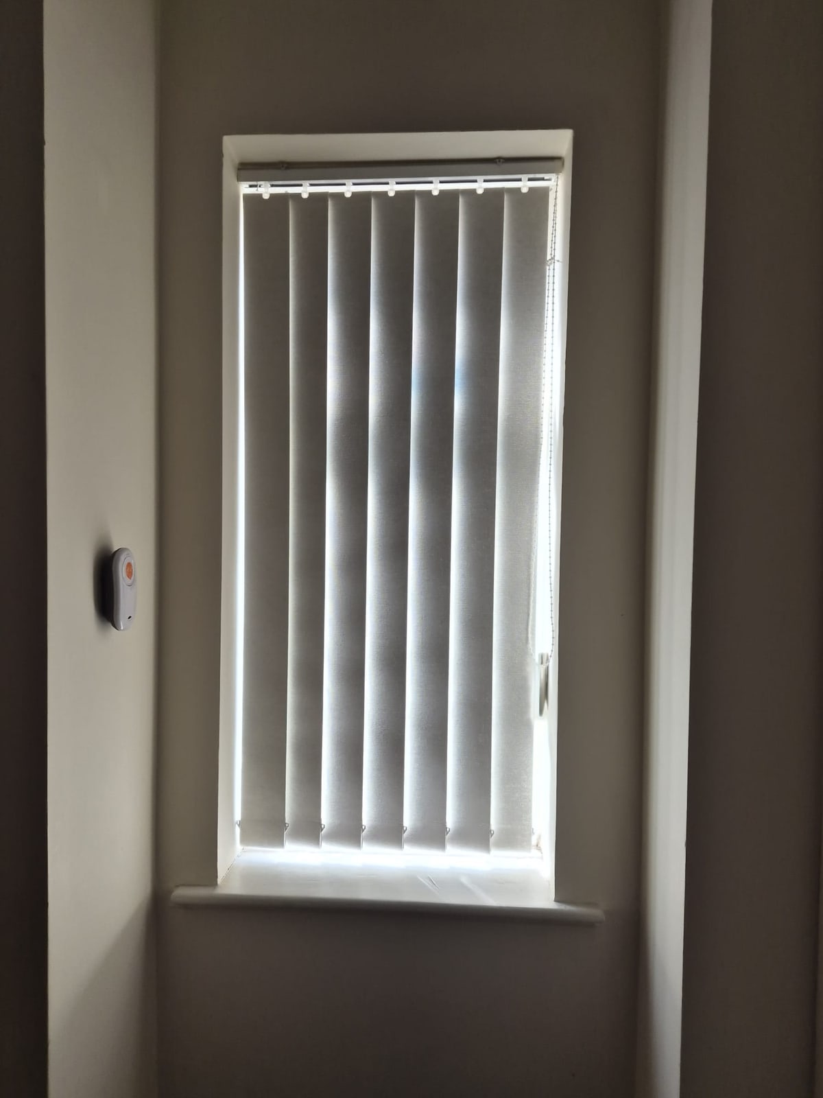 Narrow window in a Dudley home fitted with a white vertical blind