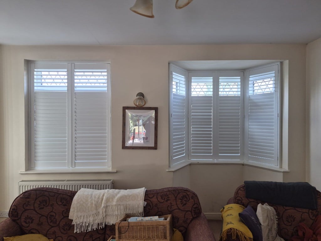 Living room Pure White composite shutters with 63mm louvres, lower closed and upper open for daylight
