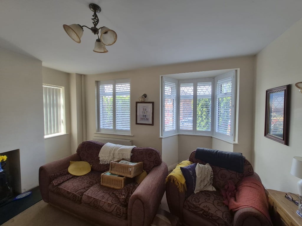 Wide view of living room Pure White full height composite shutters with louvres open