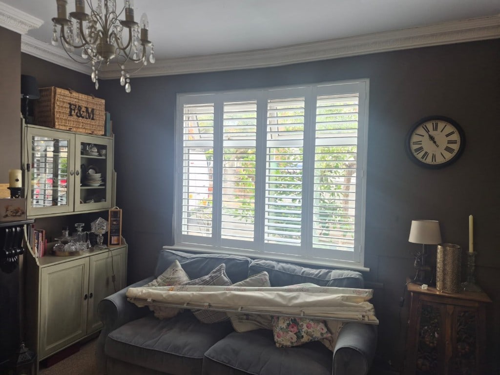 Full Height Composite Bi-folding Living Room Shutters with 76mm Louvres in Pure White. Installed in Penn, Wolverhampton. Louvres Open Side On