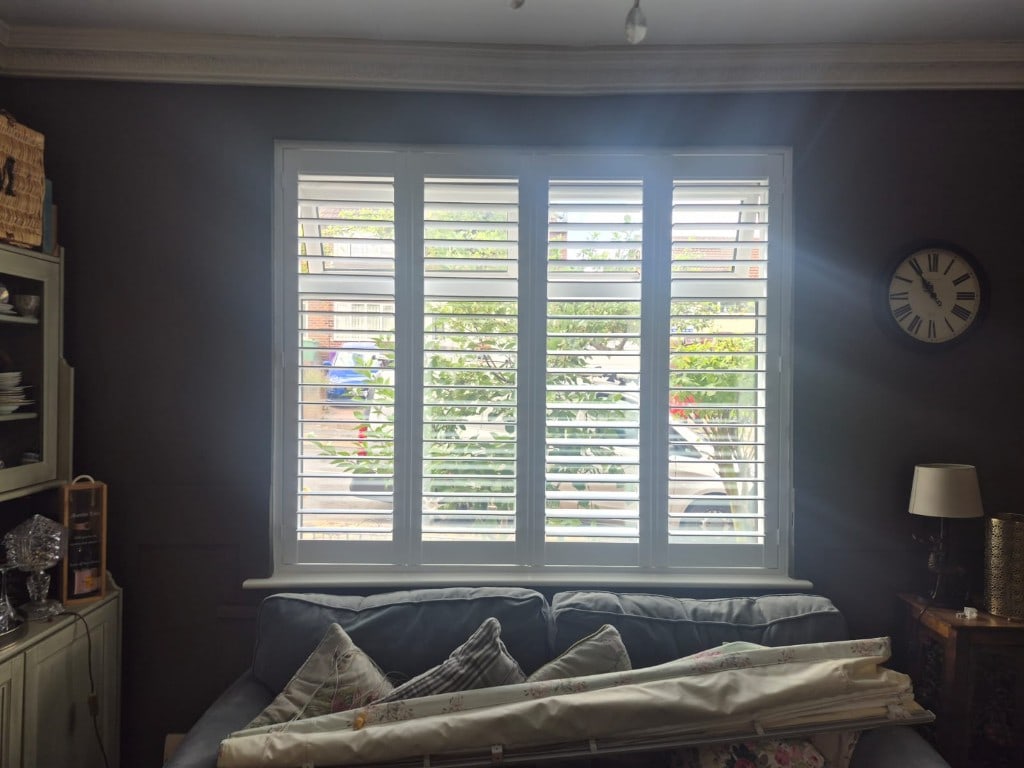 Full Height Composite Bi-folding Living Room Shutters with 76mm Louvres in Pure White. Installed in Penn, Wolverhampton. Louvres Open