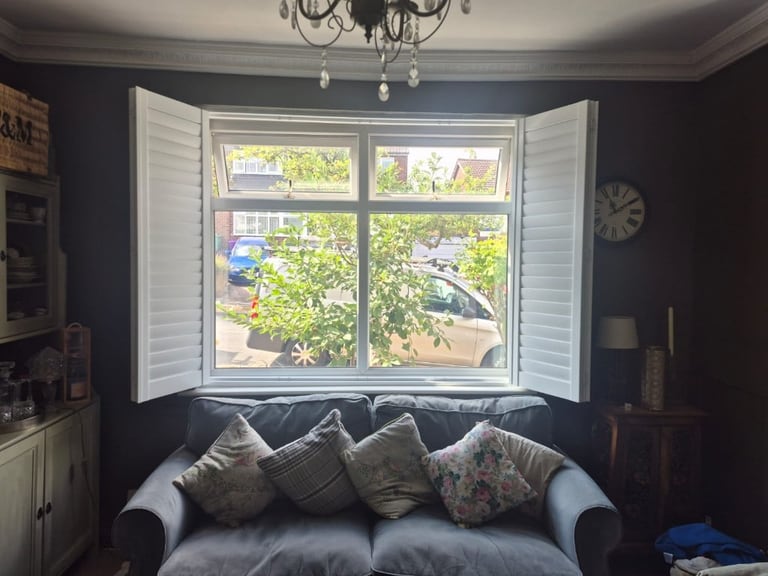 Full Height Composite Bi-folding Living Room Shutters with 76mm Louvres in Pure White. Installed in Penn, Wolverhampton. Open Straight On