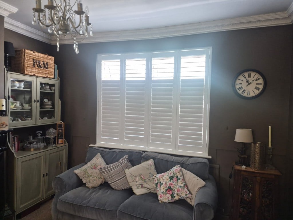 Full Height Composite Bi-folding Living Room Shutters with 76mm Louvres in Pure White. Installed in Penn, Wolverhampton. Showcasing Split Tilt Side On