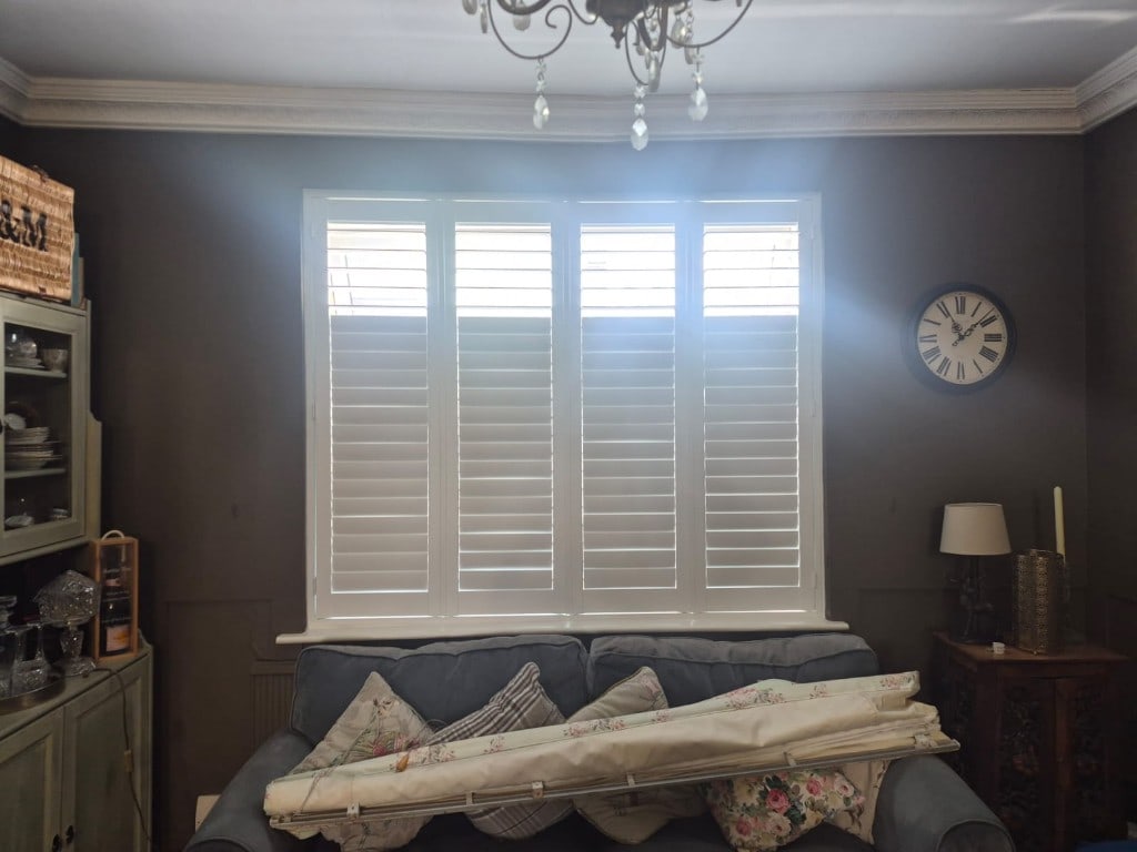 Full Height Composite Bi-folding Living Room Shutters with 76mm Louvres in Pure White. Installed in Penn, Wolverhampton. Showcasing Split Tilt