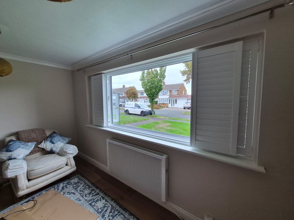 Side view of the Tipton living room with the bifold centre section of the Boston shutters folded open
