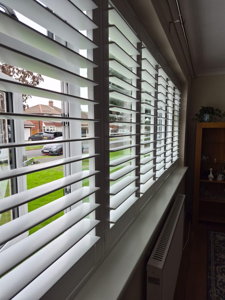 Close-up of the 76mm hardwood louvres on Pure White Boston full height shutters in Tipton