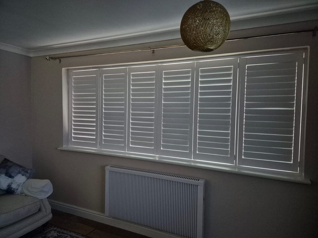 Full height Pure White Boston shutters in a Tipton living room with all louvres closed