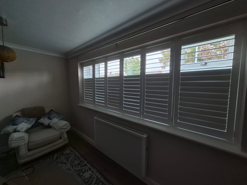 Full height Pure White Boston shutters in Tipton showing split tilt, top louvres open and bottom louvres closed