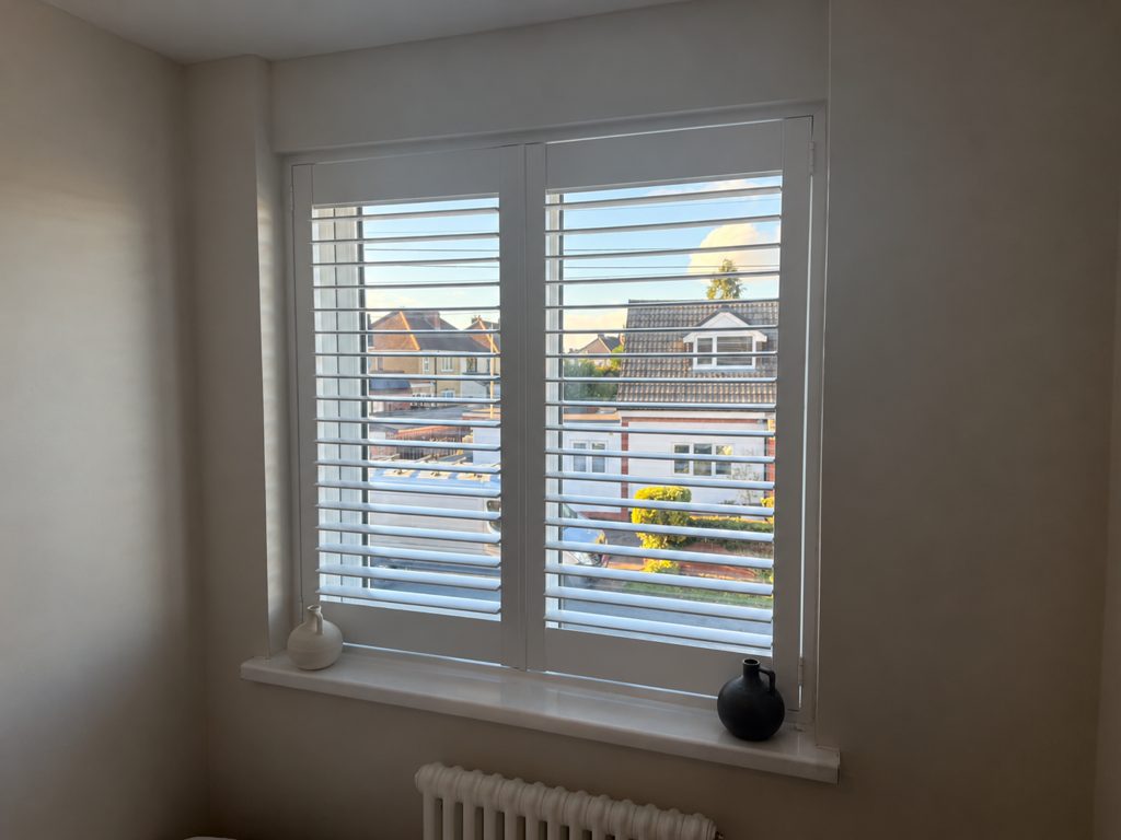 Two-panel Pure White full height shutter on the smaller Halesowen bedroom window with the louvres open