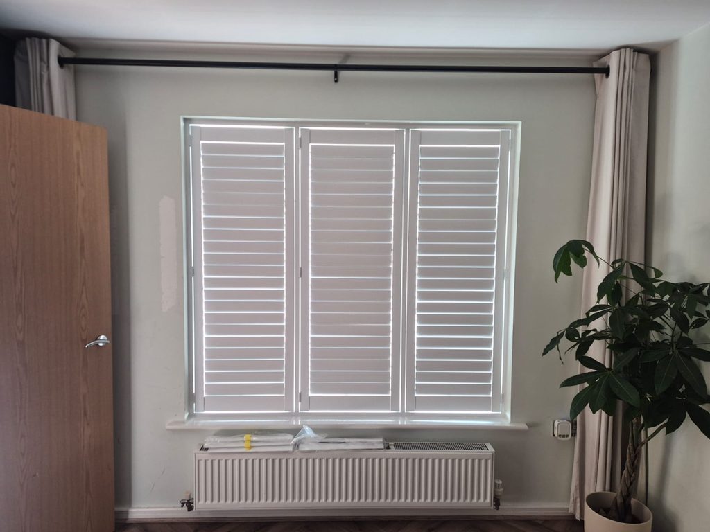 Full height Pure White Seattle shutters in a Smethwick living room with all louvres closed