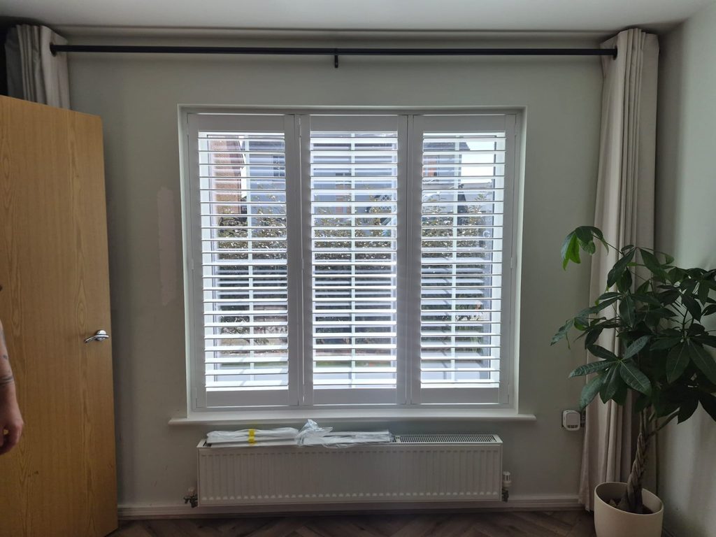 Full height Pure White Seattle shutters in a Smethwick living room with all louvres open
