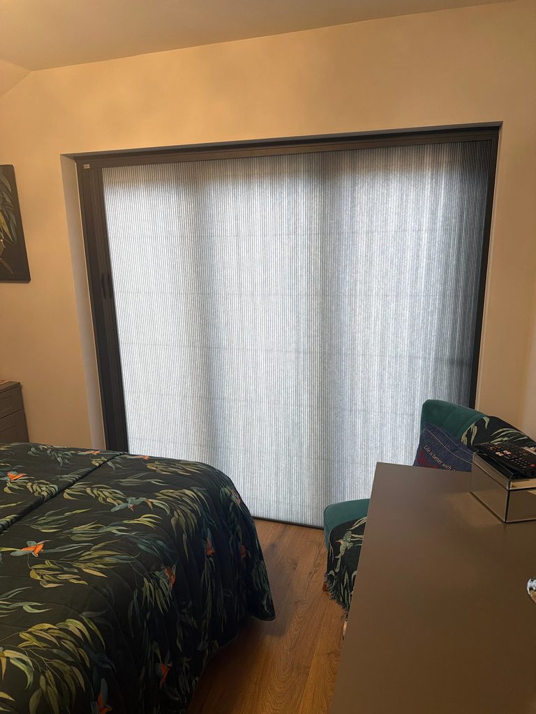 Bedroom bifold doors with the BlindScreen Scene Set fabric down, room dimmed